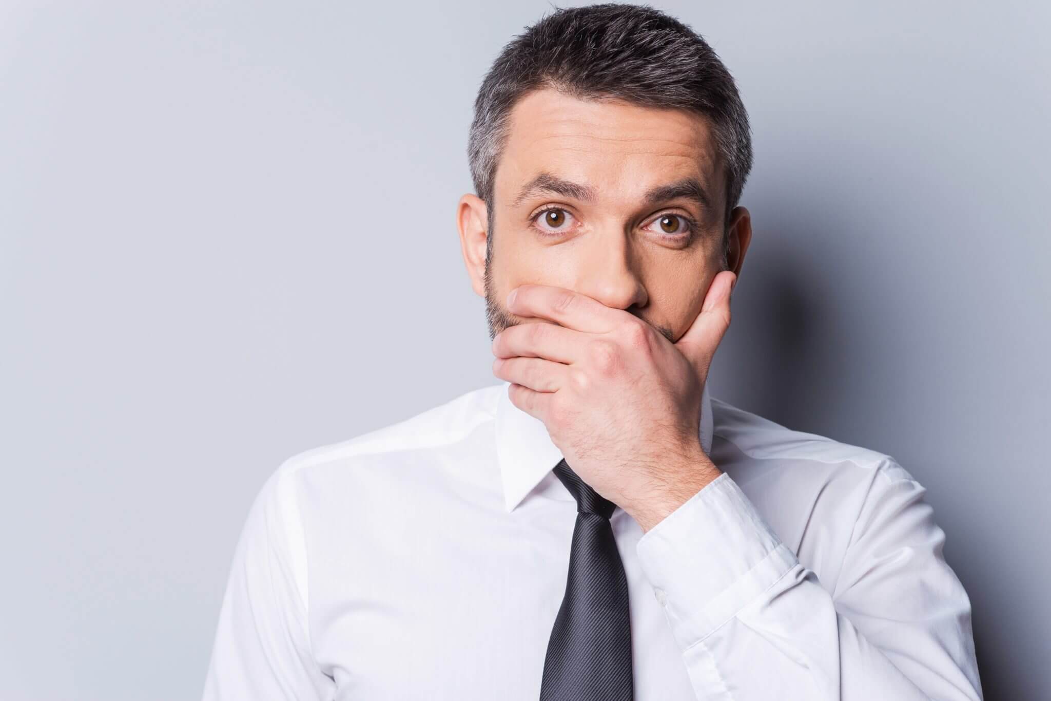 Anti-snoring appliances, man covering his mouth