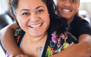 Smilesaver dental savings plan, mother and daughter smiling and hugging