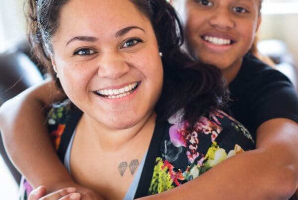 Smilesaver dental savings plan, mother and daughter smiling and hugging