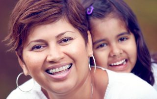 Adult braces, mother and daughter smiling