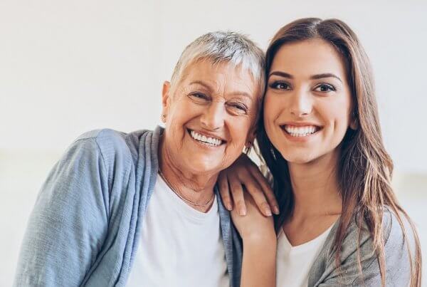 Dental plan for seniors, elderly lady with daughter smiling