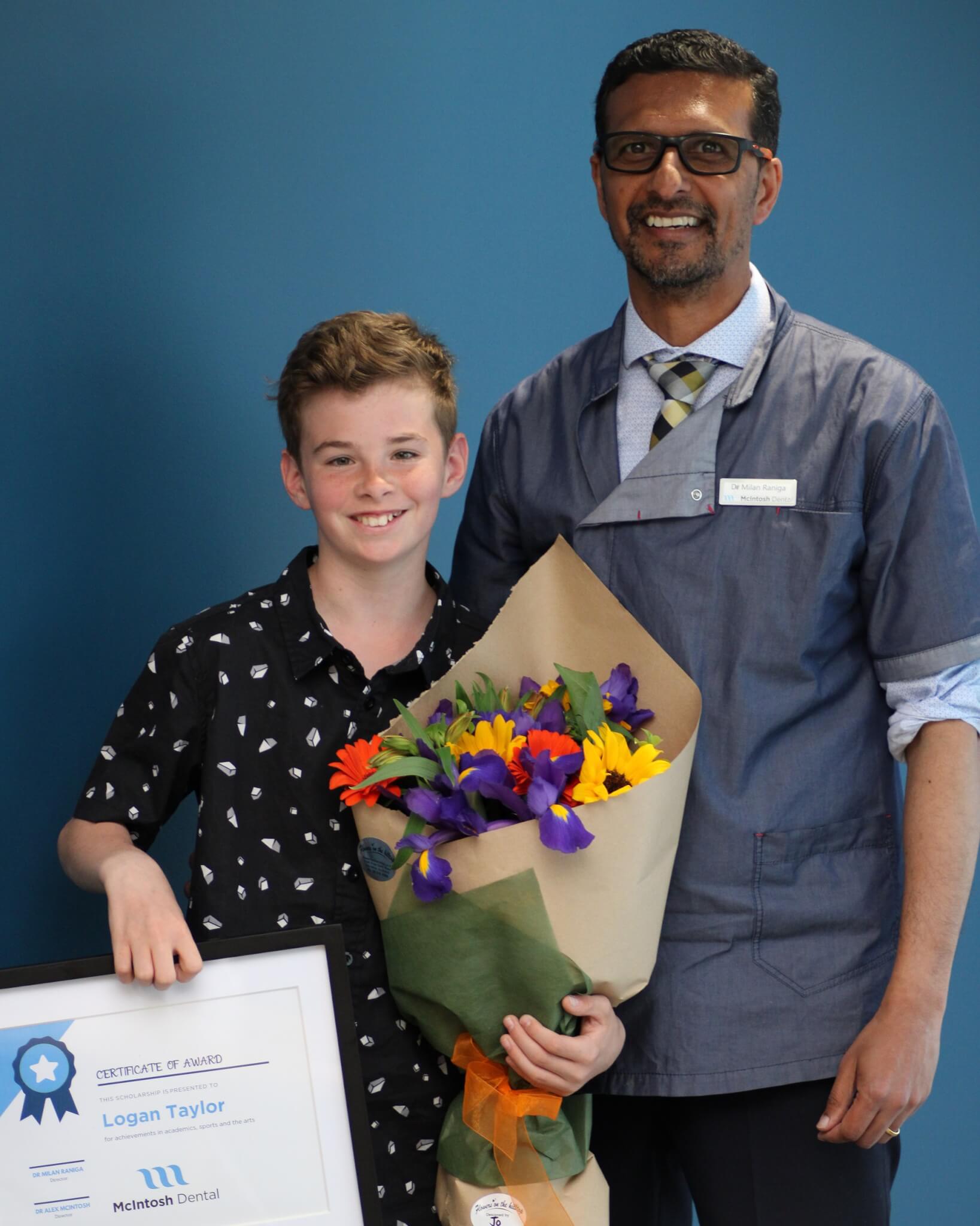 Orthodontic Scholarship Winners 2020, teenage boy holding certificate and flowers with orthodontist