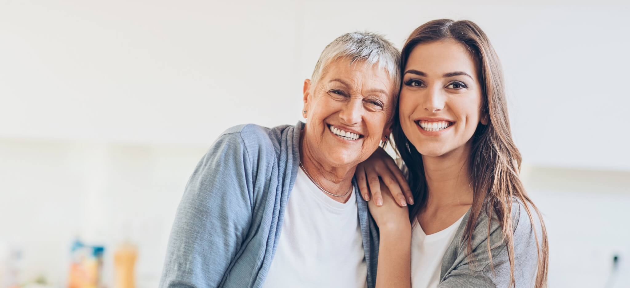 Dental implants, alternative to dentures, older lady smiling with daughter