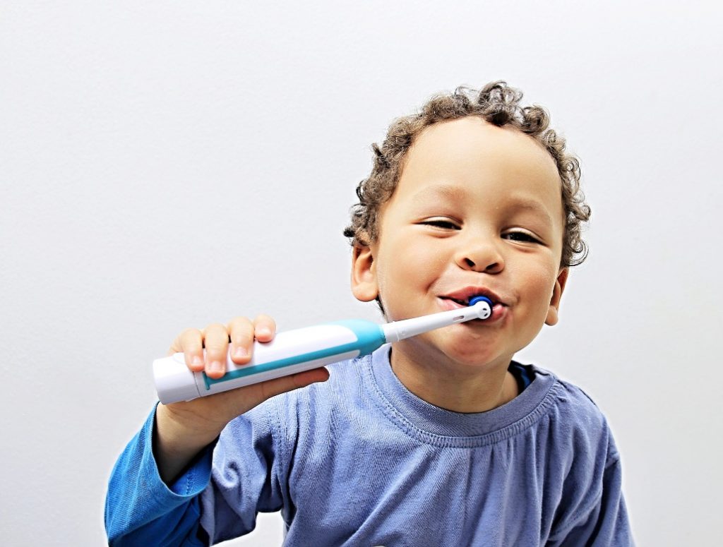 electric toothbrushes, child brushing teeth with electric toothbrush