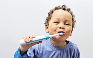electric toothbrushes, child brushing teeth with electric toothbrush