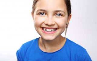 Stop bedwetting with orthodontics, girl smiling with orthodontic appliance