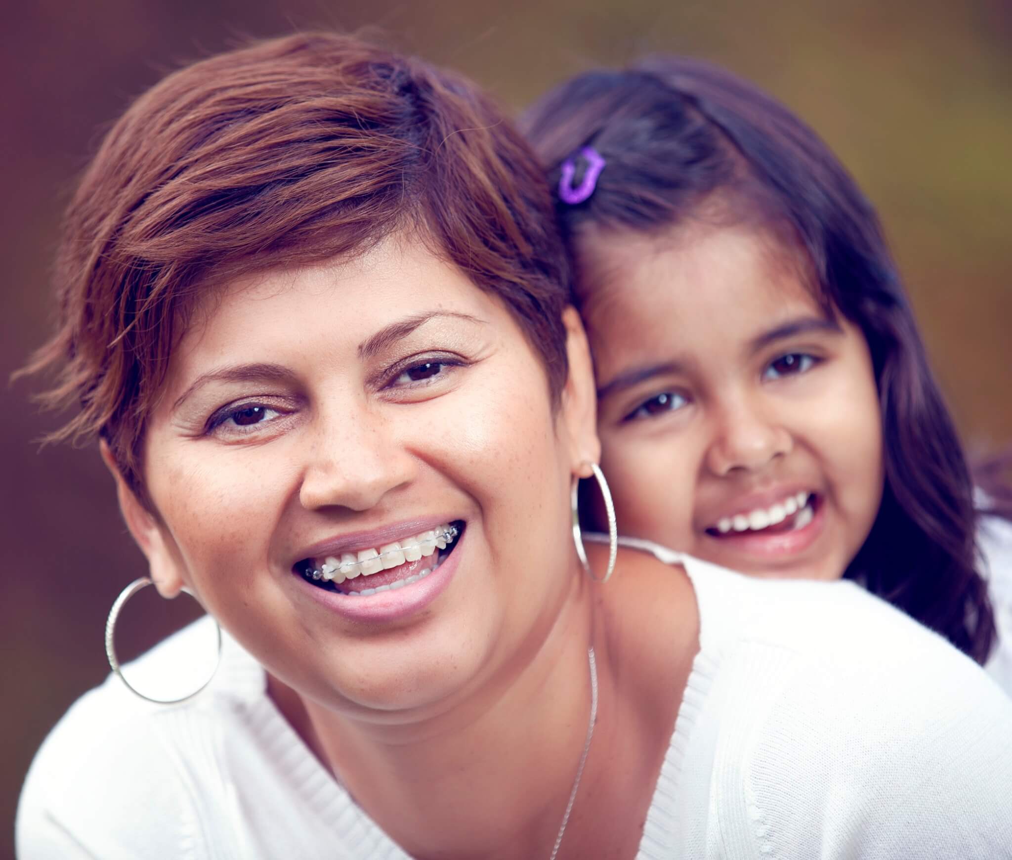 Adult braces, mother and daughter smiling