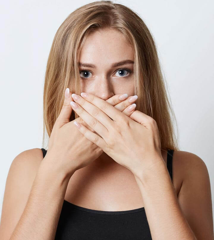 get rid of bad breath, woman holding hands over her mouth