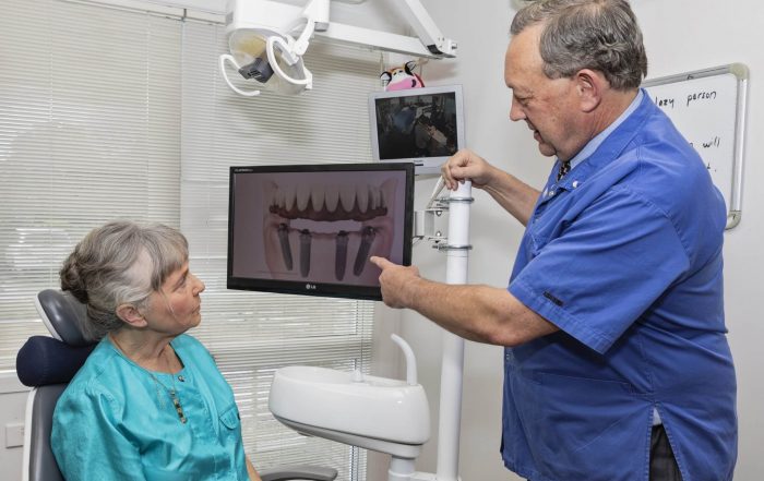 Dental implants, questions you should ask before getting a dental implant, patient with implant dentist