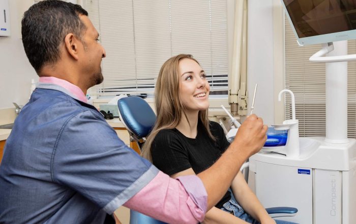 reasons to see your dentist every 6 months, dentist and patient looking at x-ray