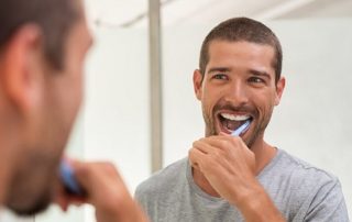 toothbrushing mistakes, man brushing his teeth